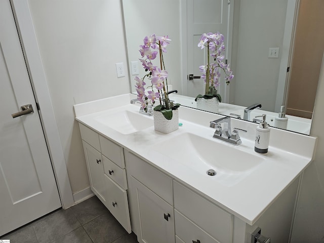 full bath with double vanity, a sink, and tile patterned flooring
