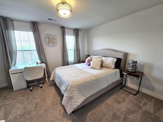 bedroom featuring baseboards, visible vents, and carpet
