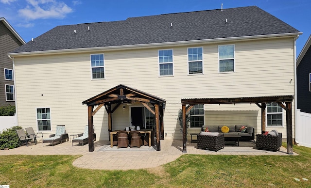 back of property with a lawn, an outdoor living space, and a fenced backyard