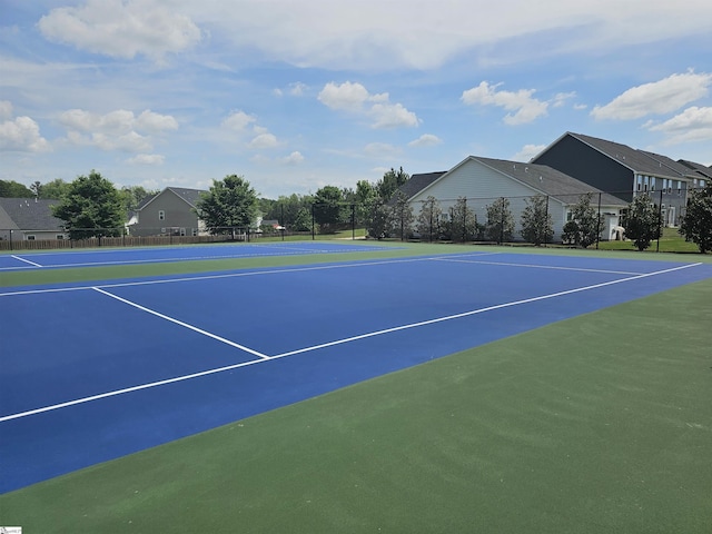 view of sport court featuring fence