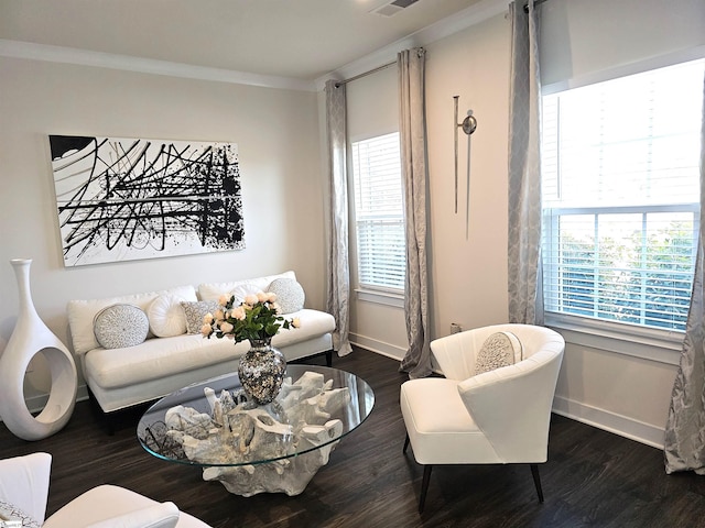 living area featuring baseboards, dark wood-style flooring, and a wealth of natural light