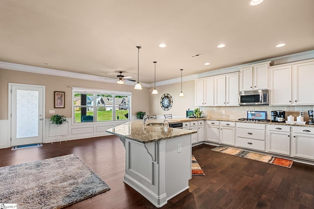 kitchen featuring crown molding, a peninsula, ceiling fan, and appliances with stainless steel finishes