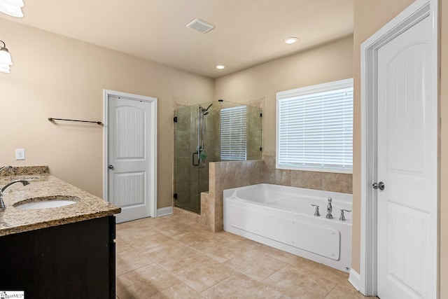 bathroom featuring tile patterned flooring, double vanity, a bath, a sink, and a stall shower