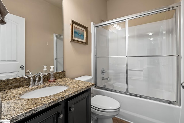 bathroom with shower / bath combination with glass door, toilet, and vanity
