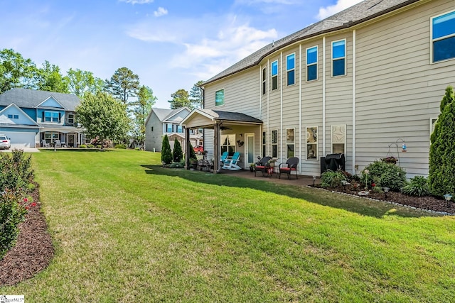 back of property featuring a lawn, a patio, and ceiling fan