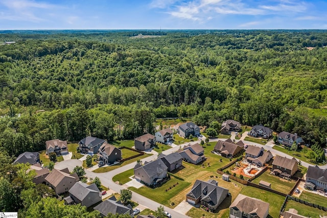bird's eye view featuring a residential view and a forest view