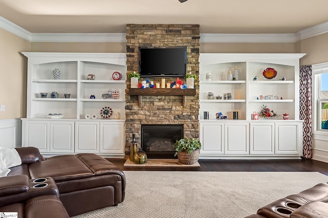 living room with a stone fireplace, ornamental molding, and dark wood-style floors