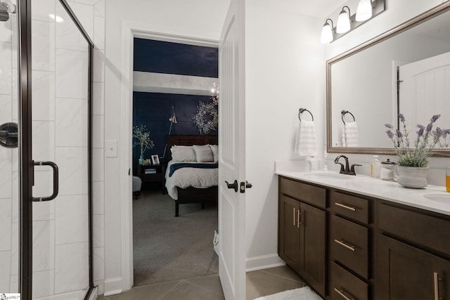 ensuite bathroom featuring tile patterned flooring, a sink, ensuite bath, and a shower stall