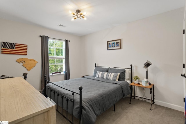 bedroom featuring a chandelier, baseboards, visible vents, and light carpet