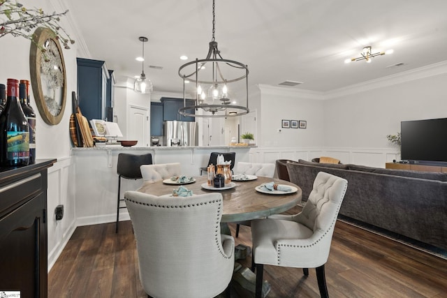 dining area with crown molding, a notable chandelier, visible vents, and dark wood-type flooring