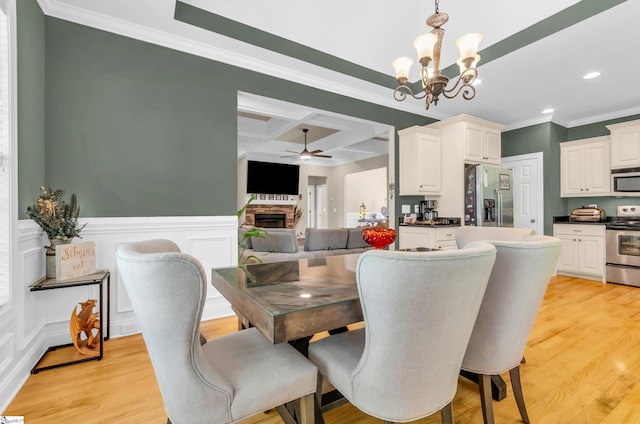 dining area with ceiling fan with notable chandelier, recessed lighting, light wood-type flooring, ornamental molding, and coffered ceiling