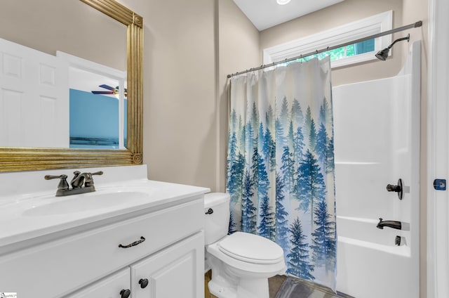 full bathroom featuring vanity, shower / bath combo with shower curtain, and toilet