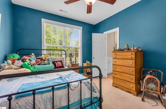 bedroom with carpet floors, ceiling fan, and visible vents