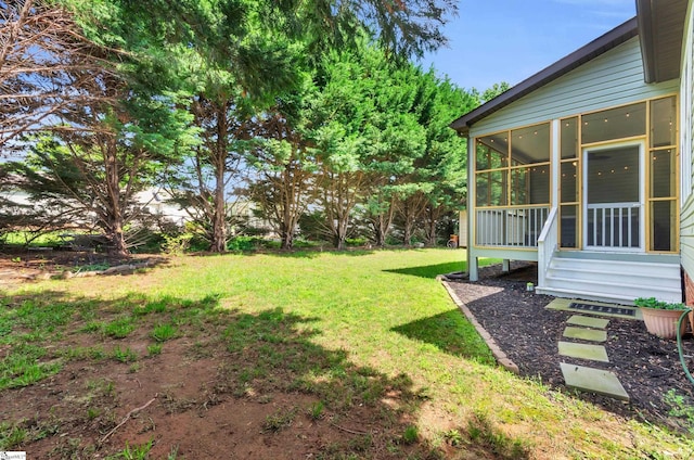 view of yard with a sunroom and entry steps