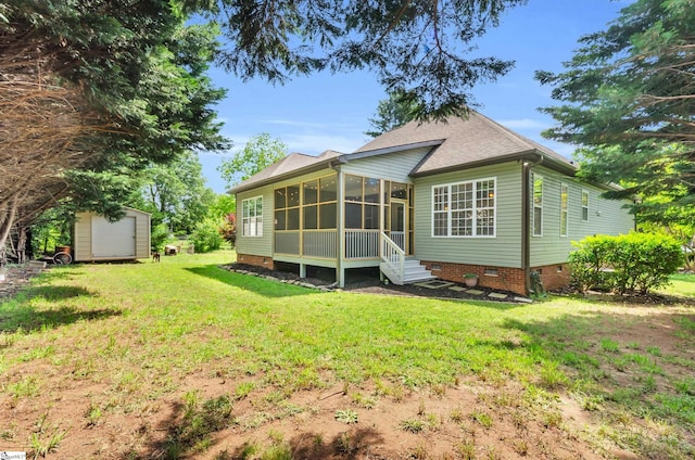 back of house with a yard, a sunroom, crawl space, a storage shed, and an outbuilding