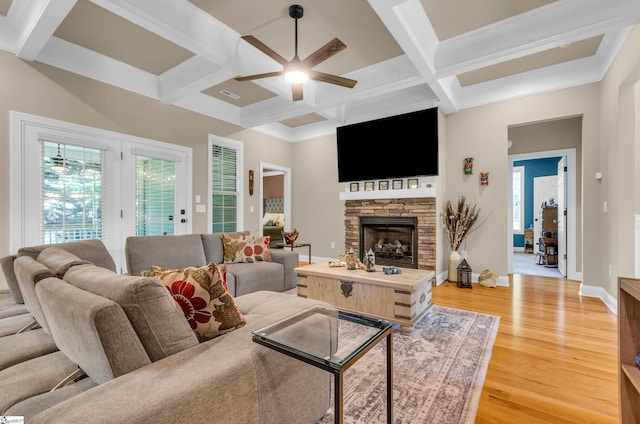 living room featuring ceiling fan, light wood finished floors, and coffered ceiling