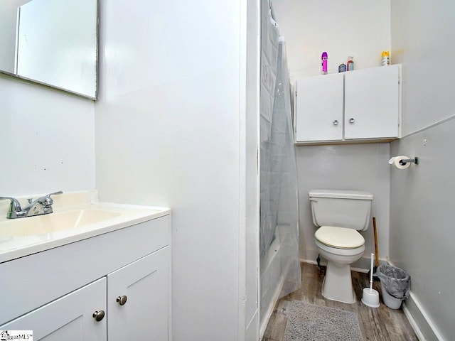 215 Louisiana St, Honea Path, SC 29654 - bathroom featuring vanity, toilet, baseboards, wood finished floors, and shower / tub combo