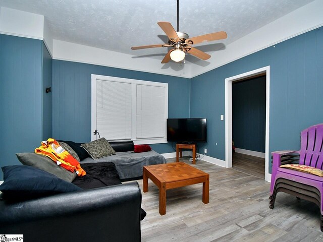 215 Louisiana St, Honea Path, SC 29654 - living area featuring a textured ceiling, baseboards, a ceiling fan, and light wood-style flooring