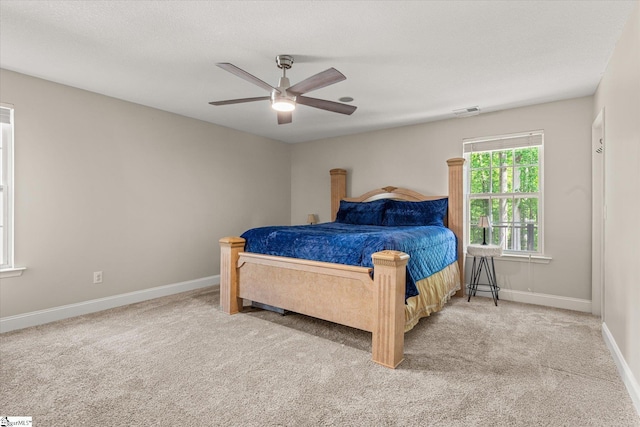 bedroom featuring baseboards, carpet, a ceiling fan, and visible vents