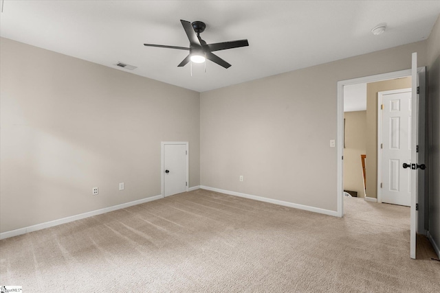 unfurnished room with visible vents, a ceiling fan, baseboards, and light colored carpet