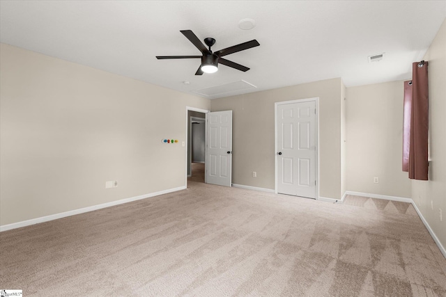 unfurnished bedroom with carpet flooring, a ceiling fan, baseboards, and visible vents