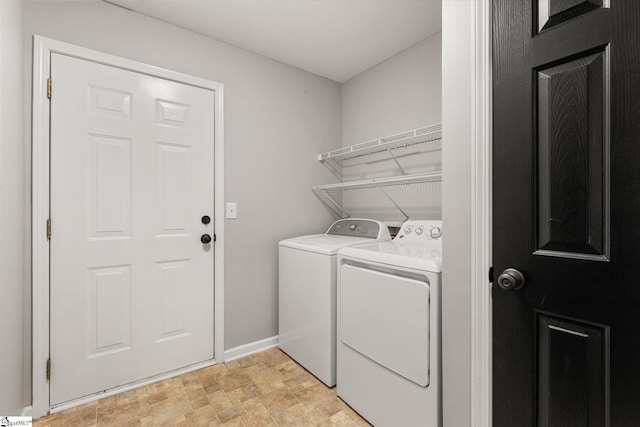 laundry area with separate washer and dryer, laundry area, and baseboards