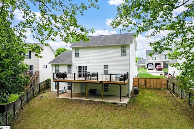 back of property featuring a deck, a fenced backyard, central AC unit, a patio area, and a yard