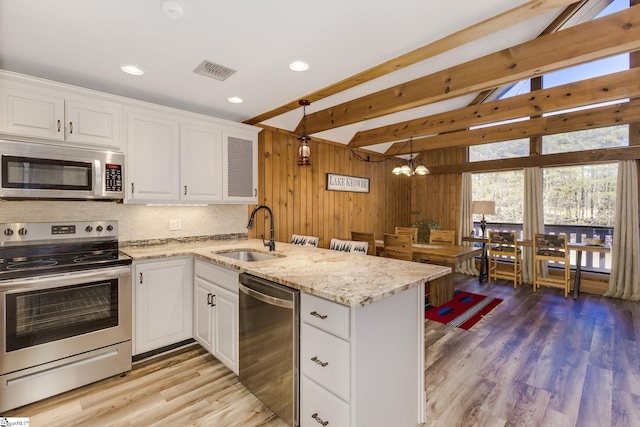 1000-2 Captains Cove Ct, Salem, SC 29676 - kitchen with white cabinets, appliances with stainless steel finishes, a sink, a peninsula, and visible vents