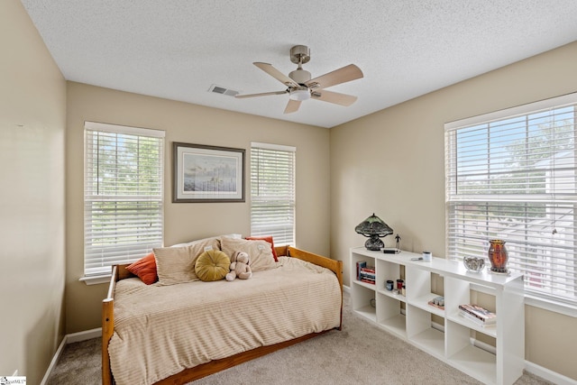 bedroom featuring visible vents, carpet, baseboards, and multiple windows