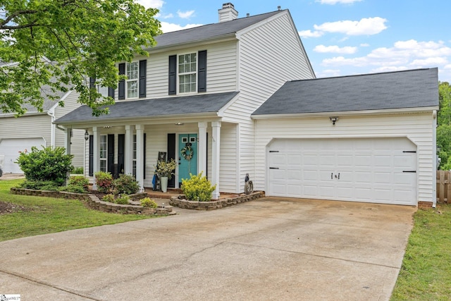traditional-style home with roof with shingles, a garage, a porch, a chimney, and driveway