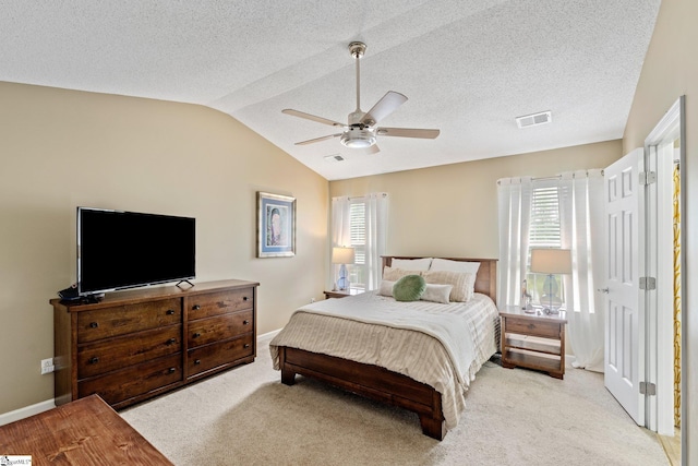 carpeted bedroom with ceiling fan, multiple windows, visible vents, and lofted ceiling