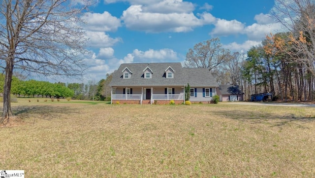 cape cod-style house featuring covered porch and a front yard