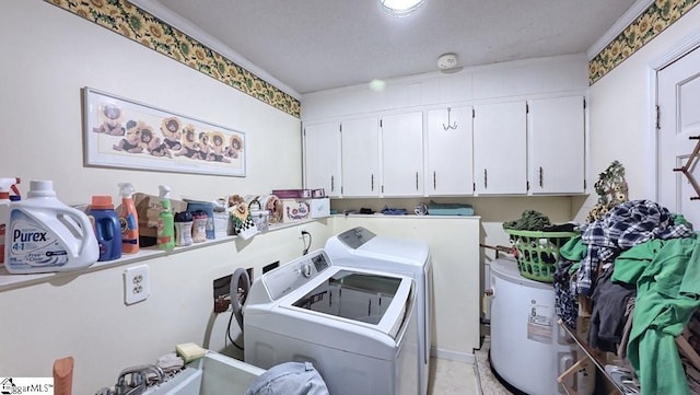 laundry room featuring cabinet space, water heater, and washing machine and dryer