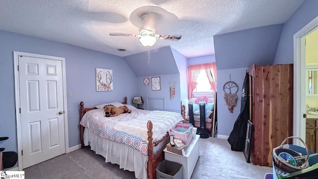 carpeted bedroom with baseboards, a ceiling fan, vaulted ceiling, and a textured ceiling
