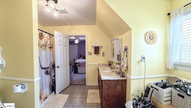 bathroom with tile patterned floors, ceiling fan, a healthy amount of sunlight, and vanity