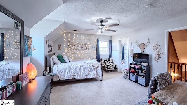 bedroom with a ceiling fan, a textured ceiling, and carpet