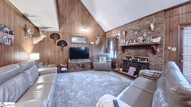 carpeted living room with wood walls and vaulted ceiling