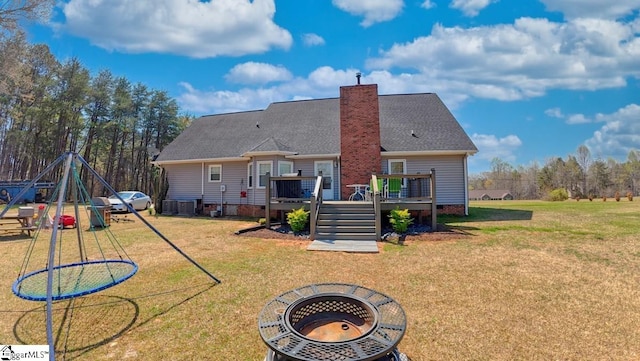back of property featuring a deck, a chimney, crawl space, a yard, and stairway