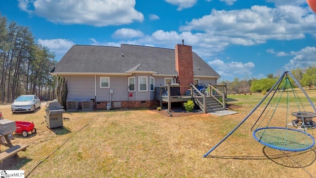 rear view of house featuring a deck, a chimney, central AC unit, crawl space, and a yard
