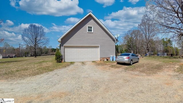 view of side of home featuring a lawn, an attached garage, and driveway