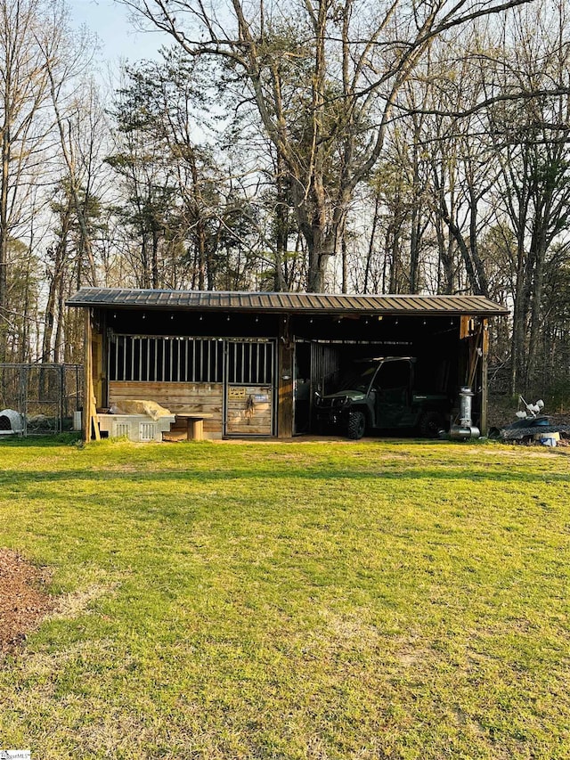 view of pole building with a lawn and a carport
