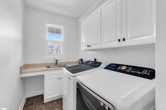 laundry room with washer and dryer, baseboards, a sink, and cabinet space