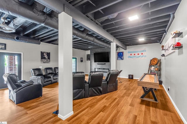 interior space featuring baseboards, plenty of natural light, and wood finished floors