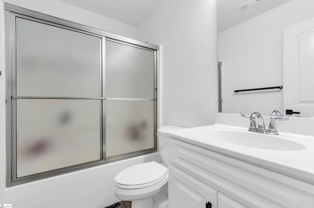 full bathroom with toilet, visible vents, bath / shower combo with glass door, and vanity