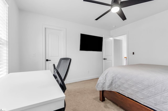 bedroom featuring baseboards, ceiling fan, and light carpet