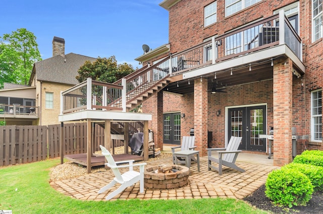 back of house featuring brick siding, a patio, stairs, and an outdoor fire pit