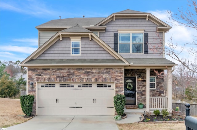 131 Riverdale Rd, Simpsonville, SC 29680 - craftsman house featuring a porch, roof with shingles, stone siding, and concrete driveway