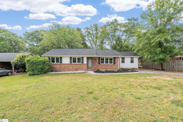 ranch-style house with brick siding, fence, driveway, and a front yard