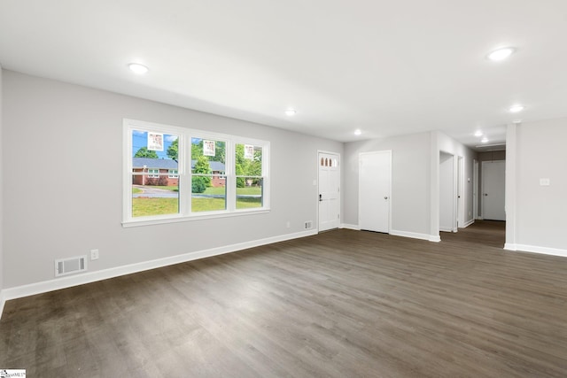 unfurnished living room featuring recessed lighting, baseboards, dark wood-style floors, and visible vents