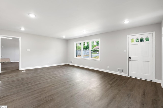 unfurnished living room featuring visible vents, recessed lighting, baseboards, and dark wood-type flooring